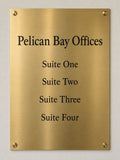 Large satin brass directory plate etched with Pelican Bay Offices and Suite One through Suite Four, mounted on four brass standoffs