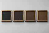 Four cast bronze samples showing the background colors, left to right: black, dark oxide, brown and duranodic bronze