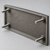Back of a cast aluminum plaque showing threaded studs for concealed mounting into drilled holes