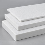Three thicknesses of white King StarBoard HDPE stacked in a fan, showing the machined cut edges side by side