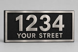 Cast aluminum address plaque with raised brushed aluminum numbers 1234 and YOUR STREET and a raised border on a black textured background