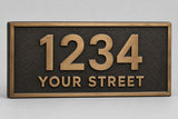 Cast bronze address plaque with raised brushed bronze numbers 1234 and YOUR STREET and a raised border on a dark oxide textured background