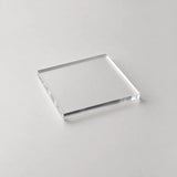 Clear half-inch acrylic sheet with defined edges on a neutral studio surface