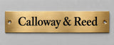 Satin brass nameplate with the words Calloway & Reed etched into the metal and filled with black, with a mounting hole at each end